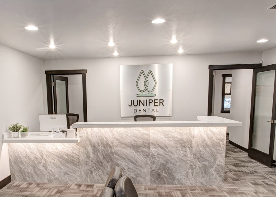 A focal point of the waiting room, the custom marbled reception desk stands light and bright